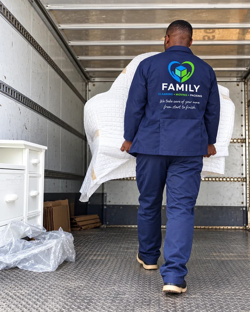 FAMILY mover handling protected furniture inside a moving truck