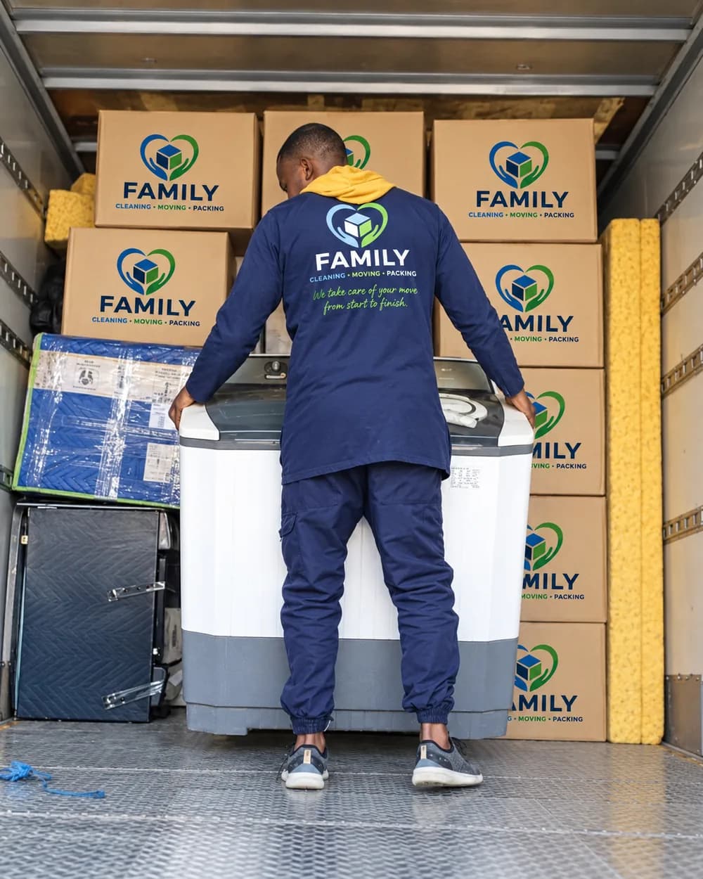 FAMILY mover organizing household items inside a moving truck