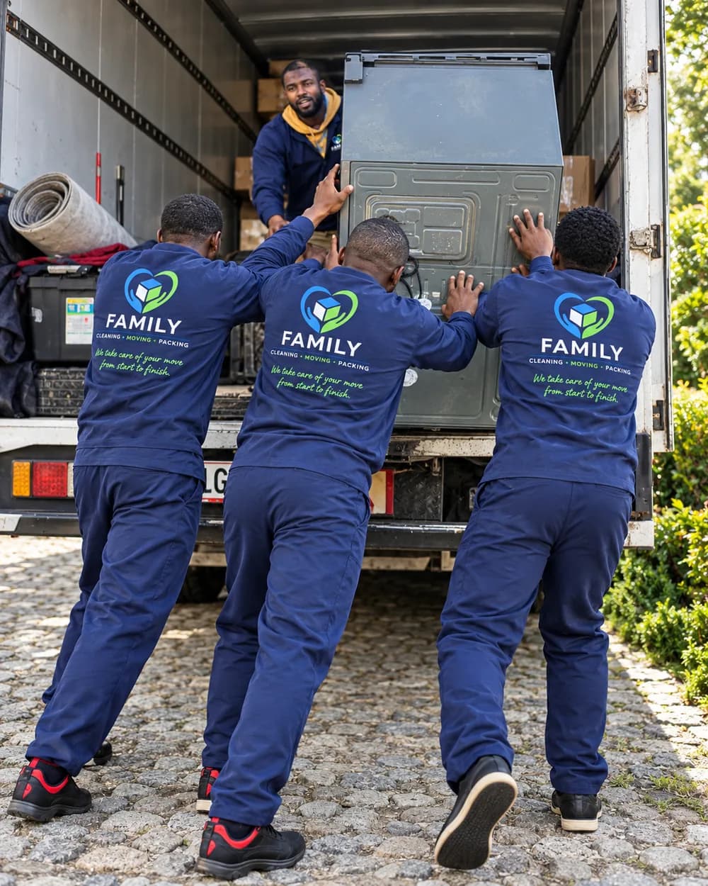 FAMILY movers loading a large appliance into a moving truck